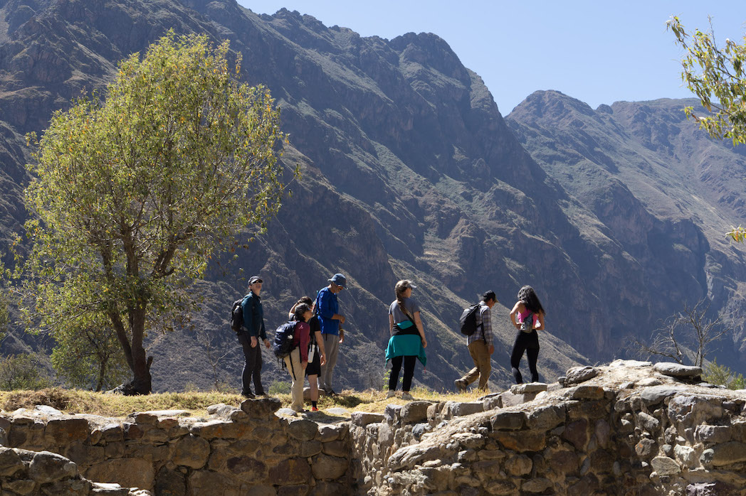 Group of travelers hiking along a mountain trail in Peru during an Unsettled adventure